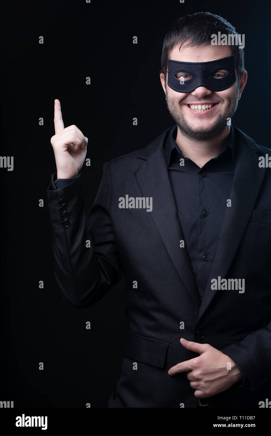 man in black mask, jacket on empty black background Stock Photo Alamy