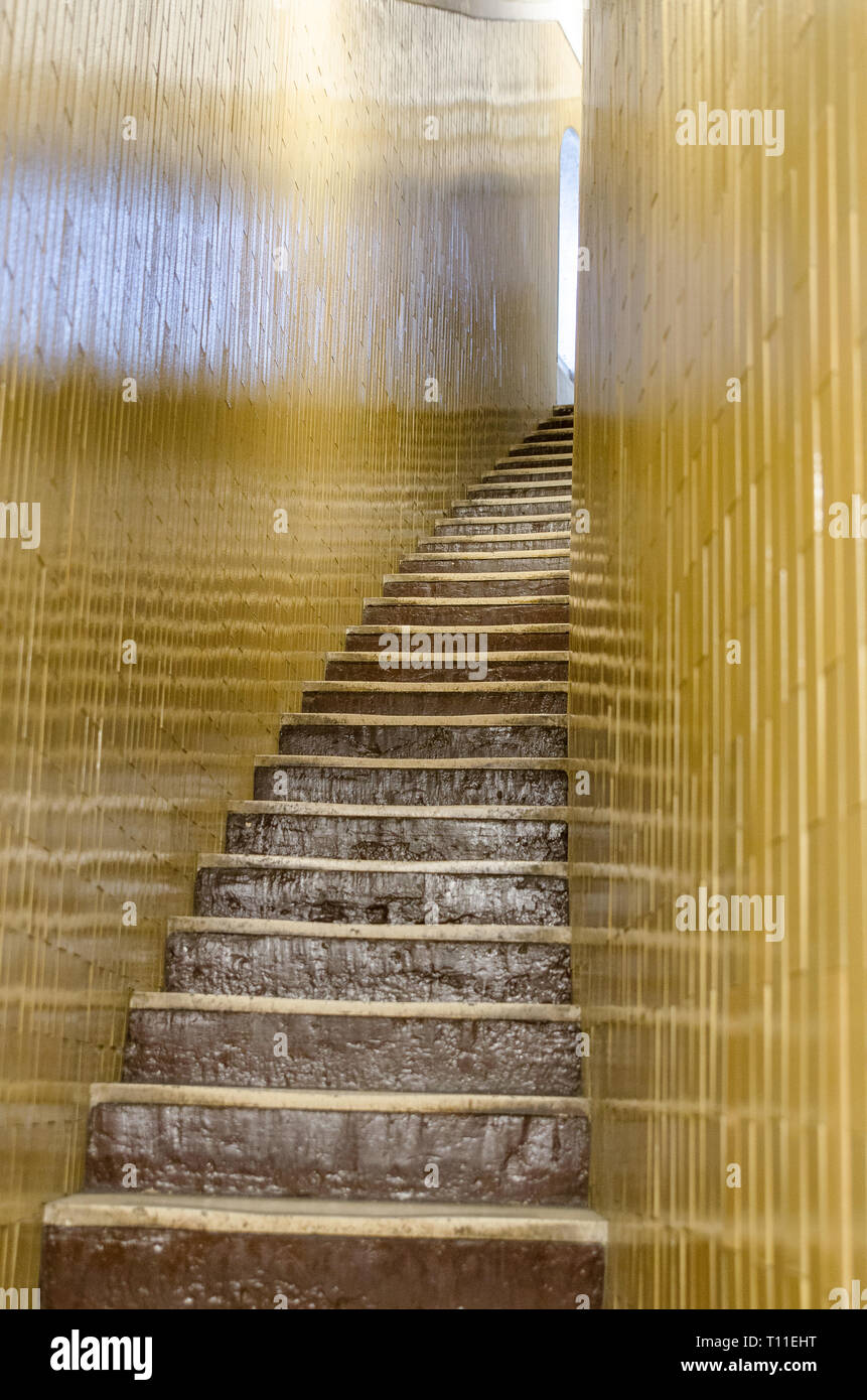 VATICAN CITY, ITALY, APRIL 27,2017: A photograph documenting the difficult to climb, narrow curved staircase with gold coloured bricks forming the wal Stock Photo