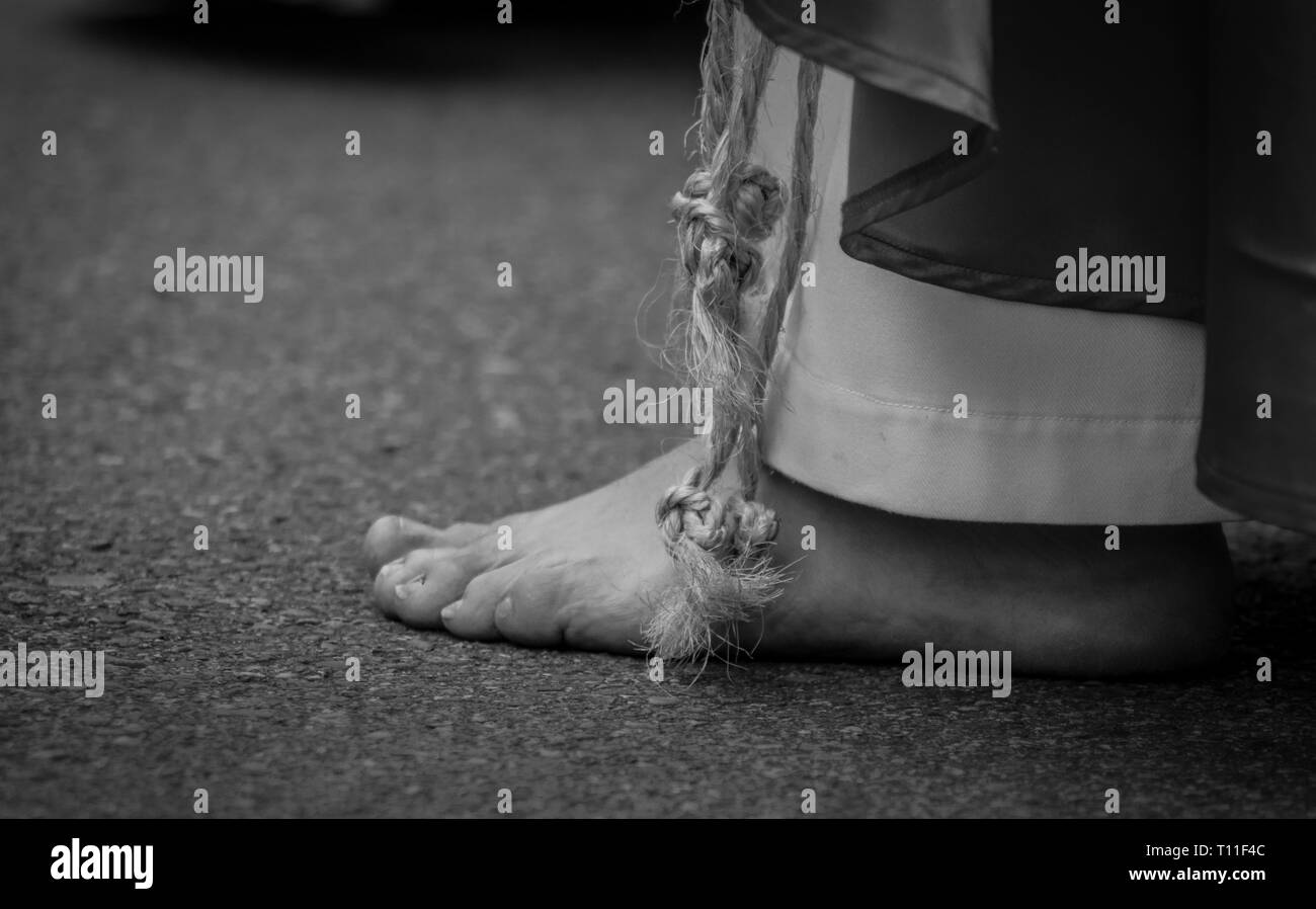 Holy Week Foot Procession A person walks barefoot during a procession in the celebration of Holy ...