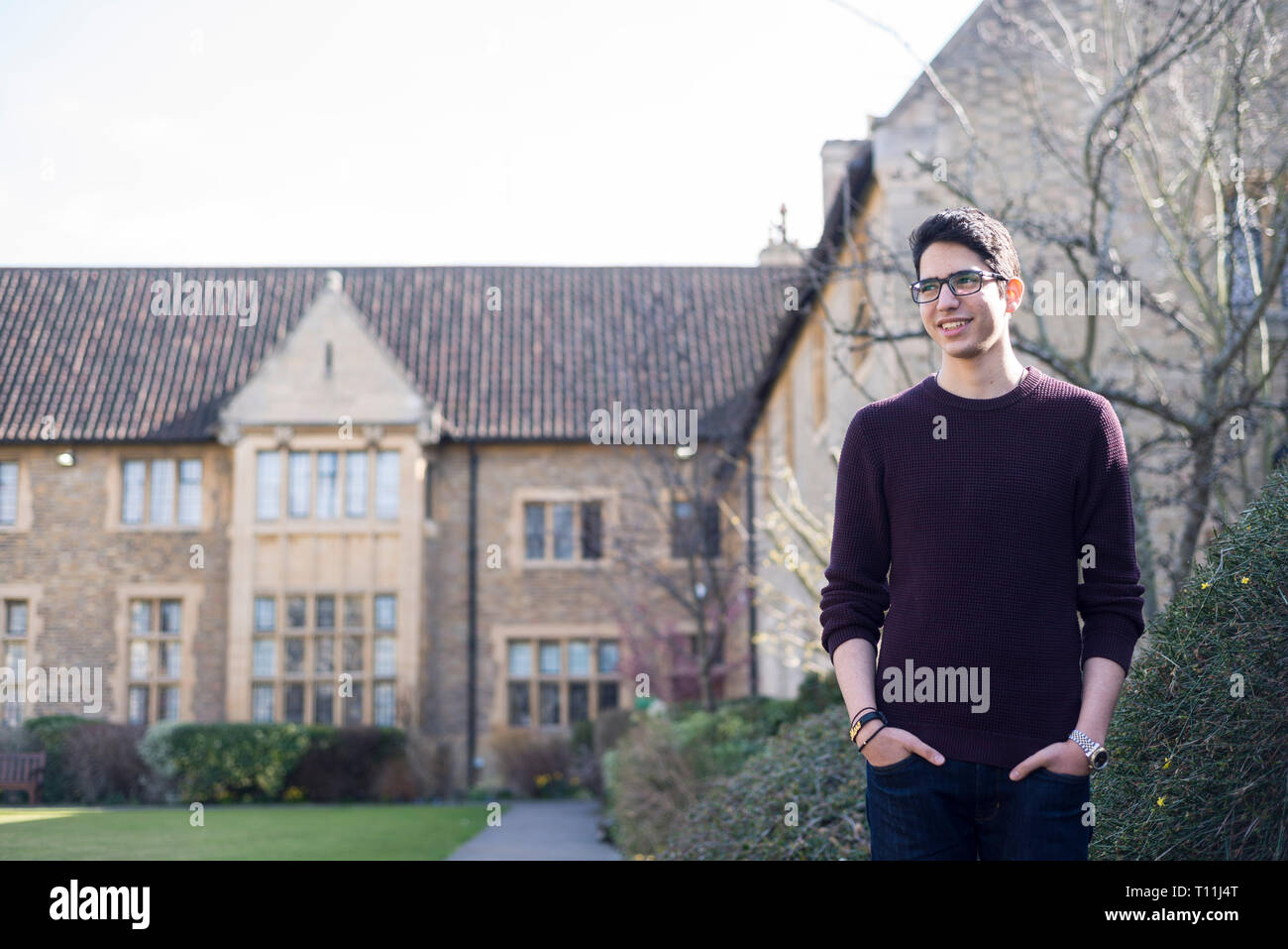 An arabic student from the Middle East outside in a traditional Oxbridge college Stock Photo