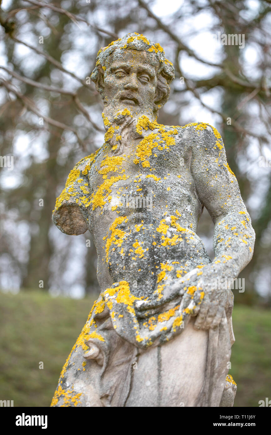 Moss on an old stone goddess statue in the park in Rogalin / Poland