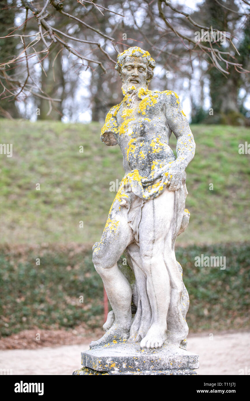 Moss on an old stone goddess statue in the park in Rogalin / Poland