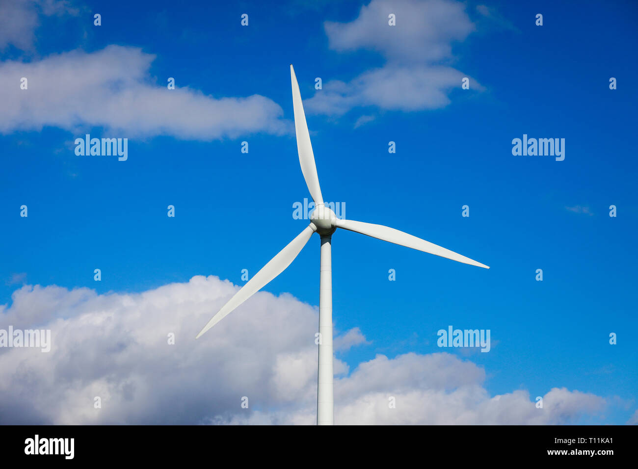 Ense, North Rhine-Westphalia, Germany - Windmill in front of a blue sky with clouds. Ense, Nordrhein-Westfalen, Deutschland - Windrad vor blauem Himme Stock Photo