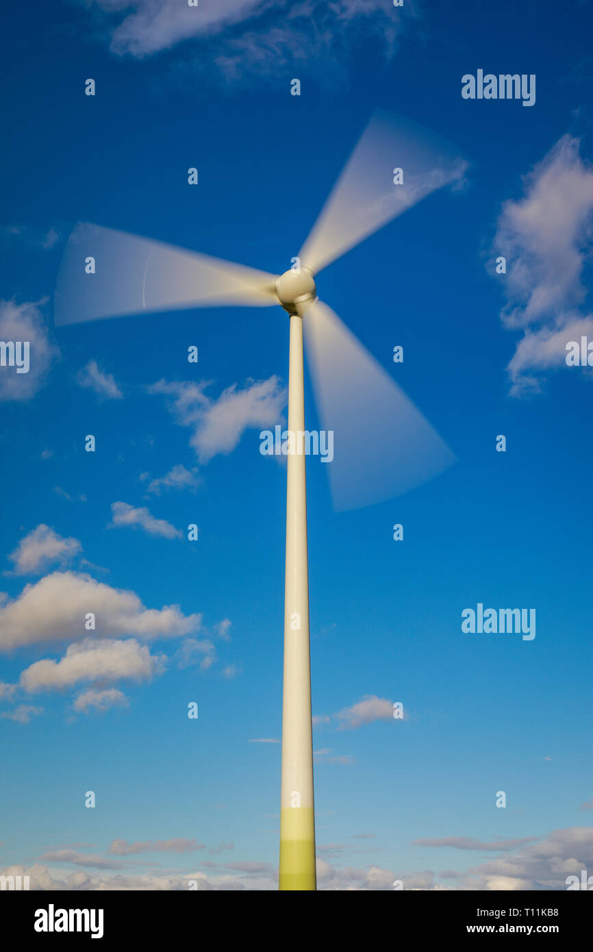 Ense, North Rhine-Westphalia, Germany - Wind turbine in front of a blue sky with clouds. Ense, Nordrhein-Westfalen, Deutschland - Windrad vor blauem H Stock Photo