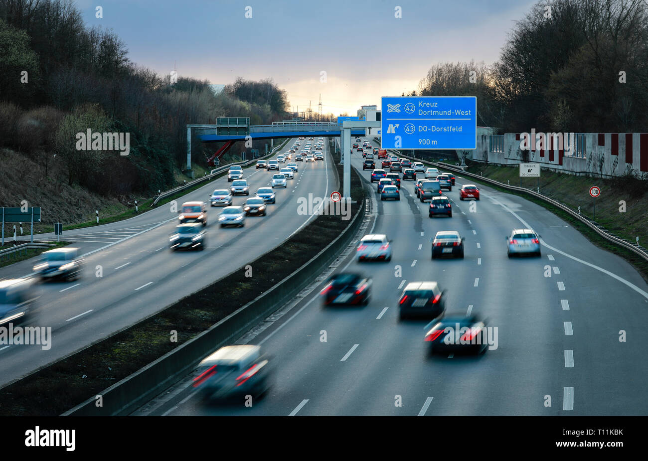 Dortmund, Ruhr area, North Rhine-Westphalia, Germany - Cars in the evening traffic on the Ruhr highway A40 in the evening at the intersection Dortmund Stock Photo