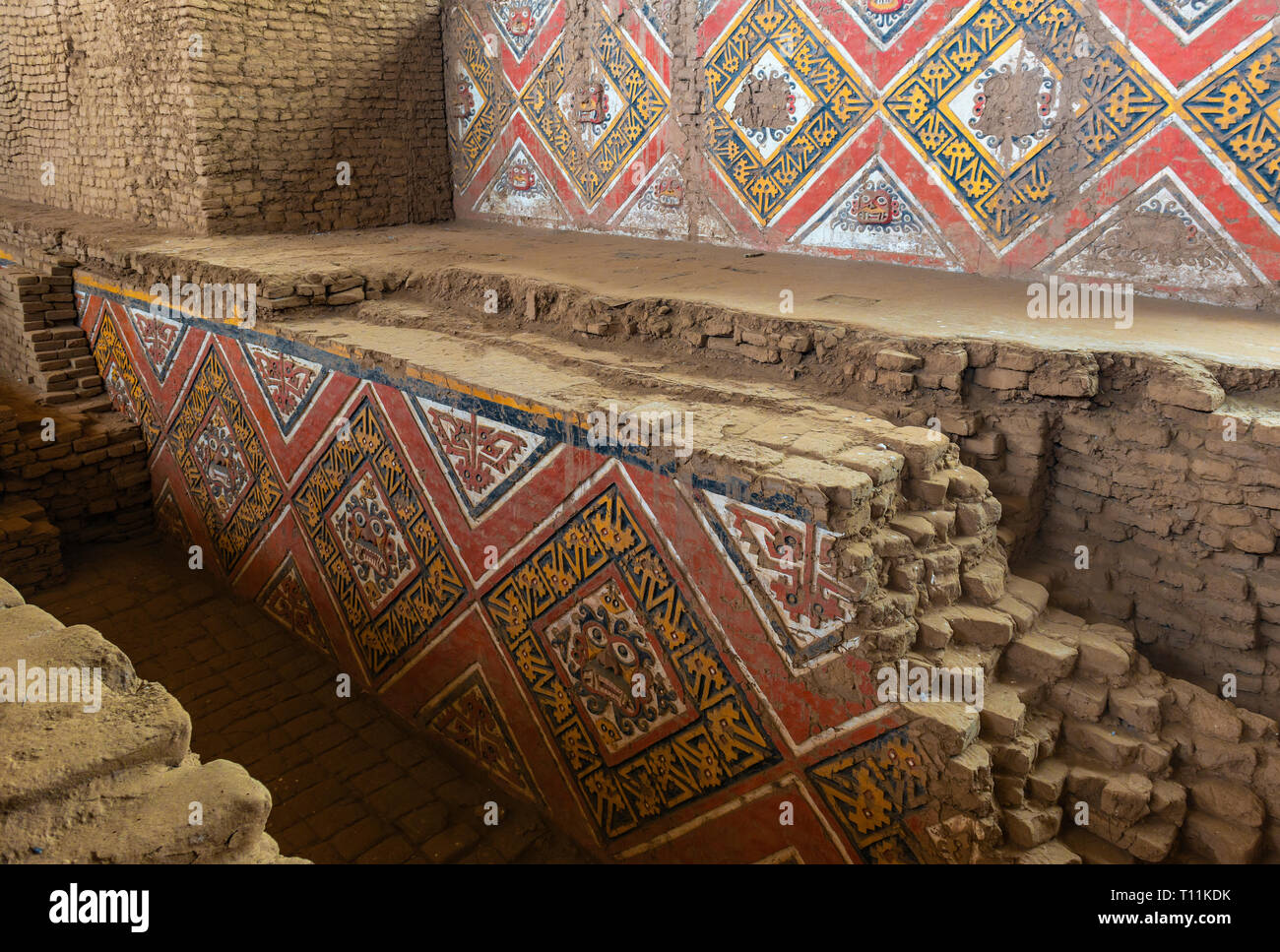 Huaca de la Luna or Moon Pyramid in adobe bricks with colorful bas relief of creator god Ai Apaec of the Moche or Mochica culture, Trujillo, Peru. Stock Photo