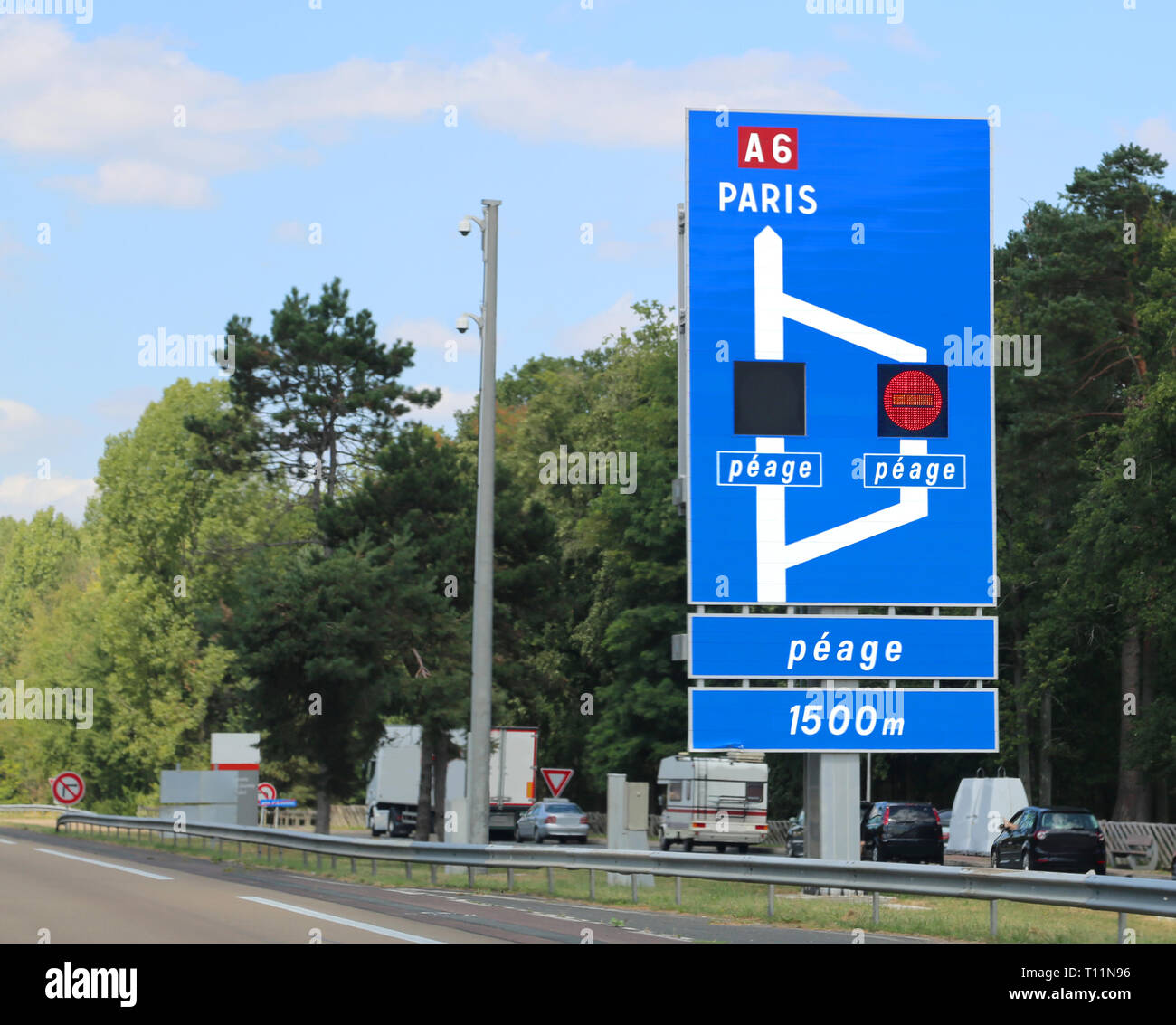 French motorway and indications to Paris in France. The french text Peage means toll payment in