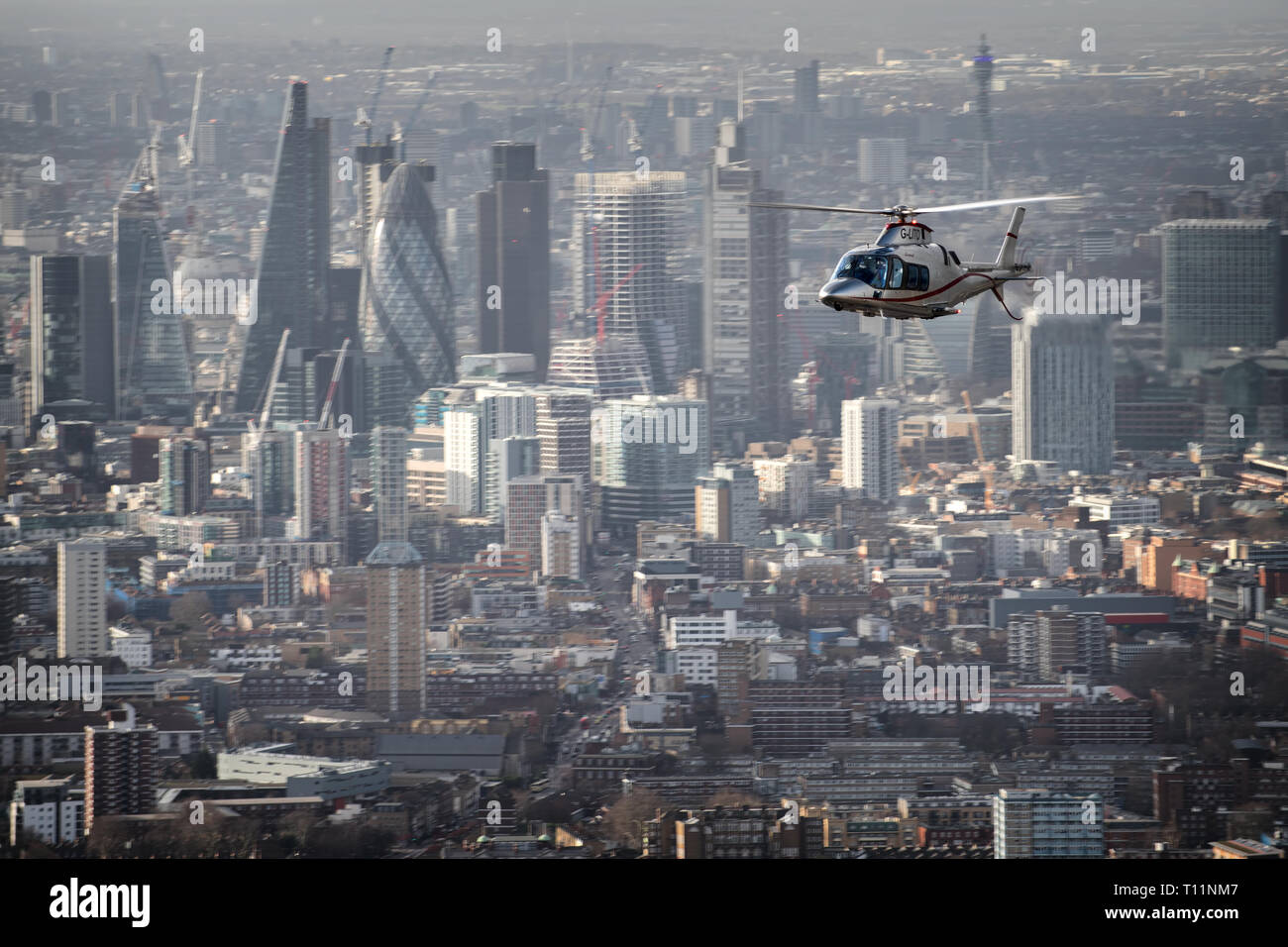AW109 charter helicopter flying over London during an aerial photoshoot. Stock Photo