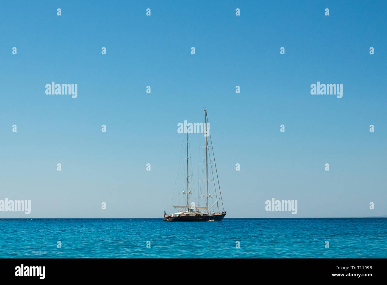 Greece, Zakynthos.  Glamorous yacht under a wide blue sky. Stock Photo