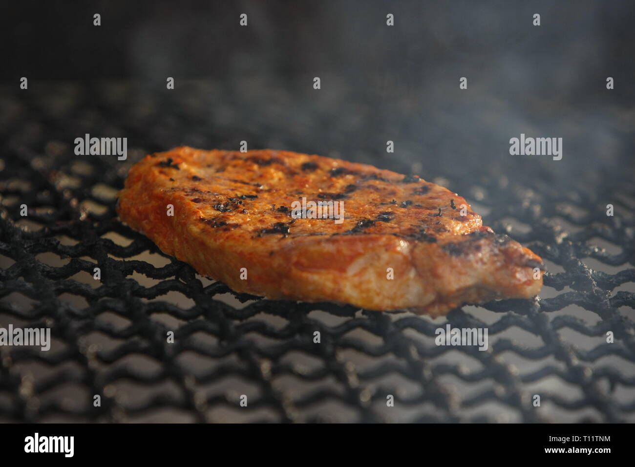 a marinated steak on the grill Stock Photo Alamy