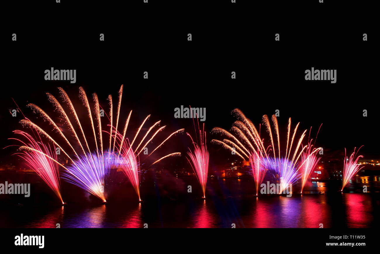 Fireworks show,colorful fireworks on the black sky background, fireworks explosion in the dark sky with city silouthe on bottom, fireworks in Malta Stock Photo