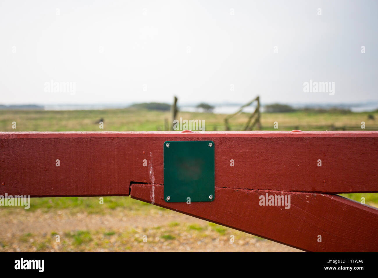 A green meadow locked with a red barrier and prohibition sign Stock Photo