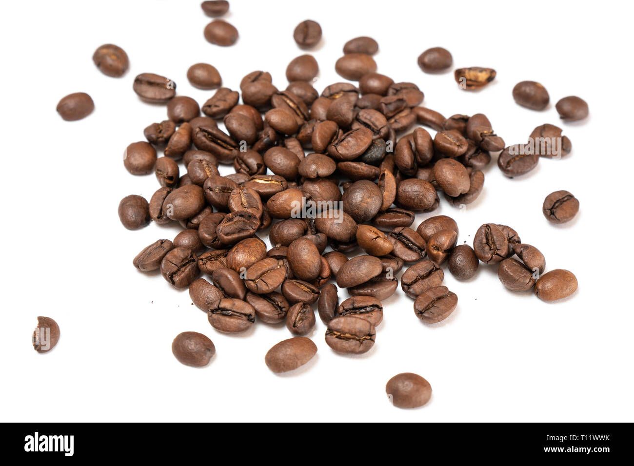 some coffee beans on a plain white table Stock Photo