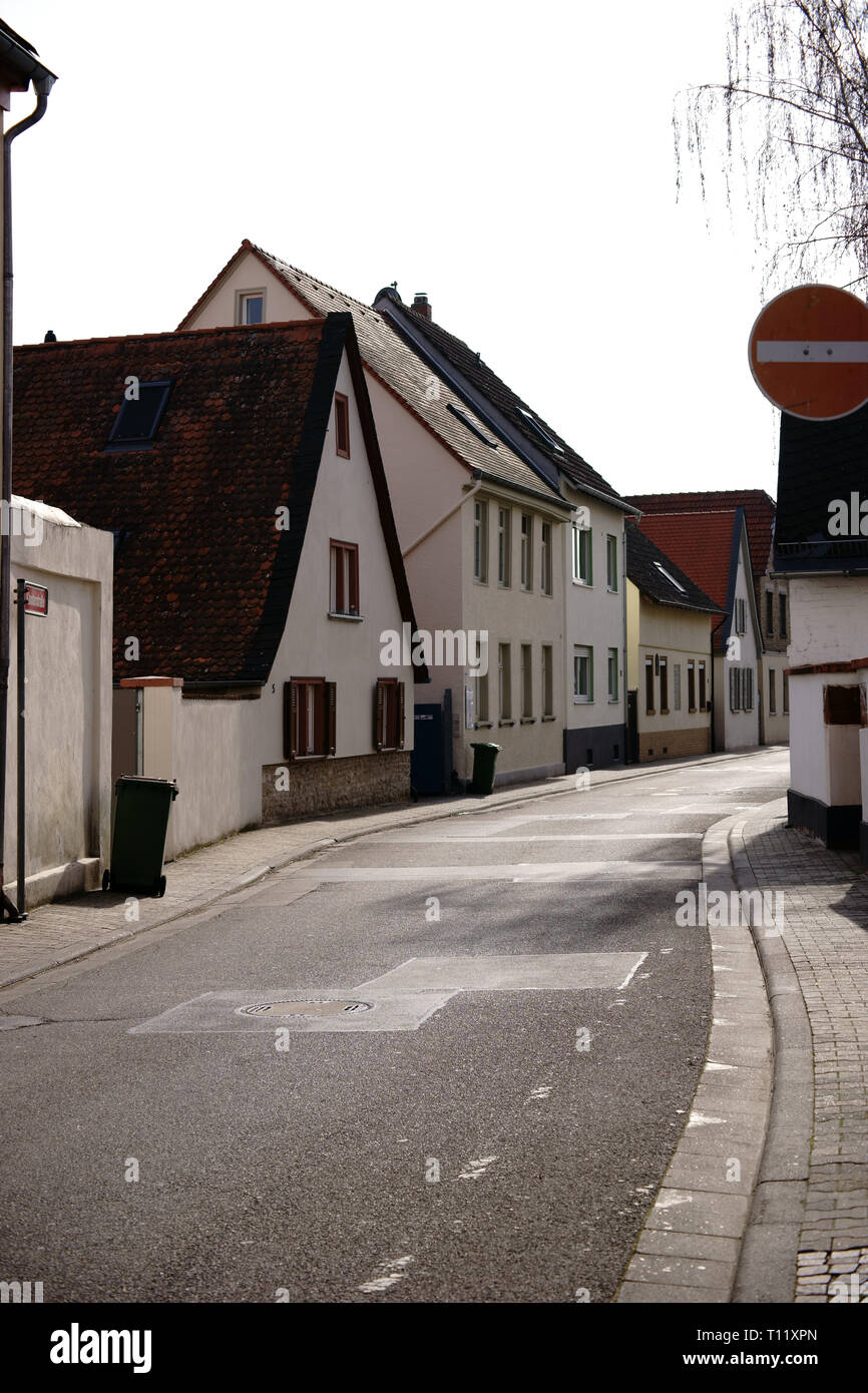 A winding village street with houses on the roadsides. Stock Photo