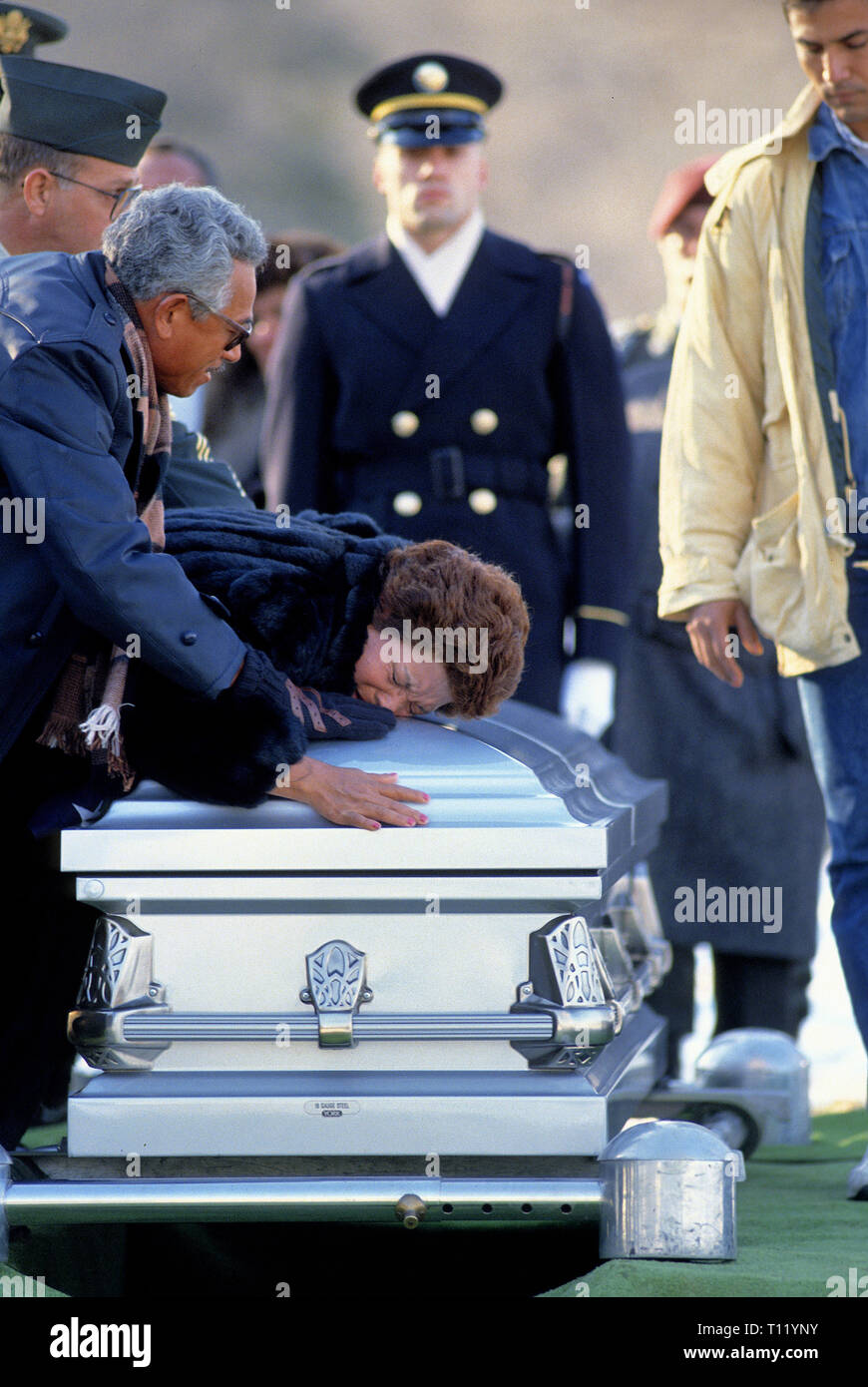 Arlington, Virginia 12-28-1989 The mother of Alejandro L. Manriquelozano, Specialist, USA Ranger battalion, lies weeping over his casket during his funeral today at Arlington National Cemetery.  Specialist Alejandro L. Manriquelozano, 30, was buried with military honors, including 3 rifle volleys and the playing of taps, in snow-covered ground at Arlington within sight of the Capitol and Washington Monument. Credit: Mark Reinstein/MediaPunch Stock Photo
