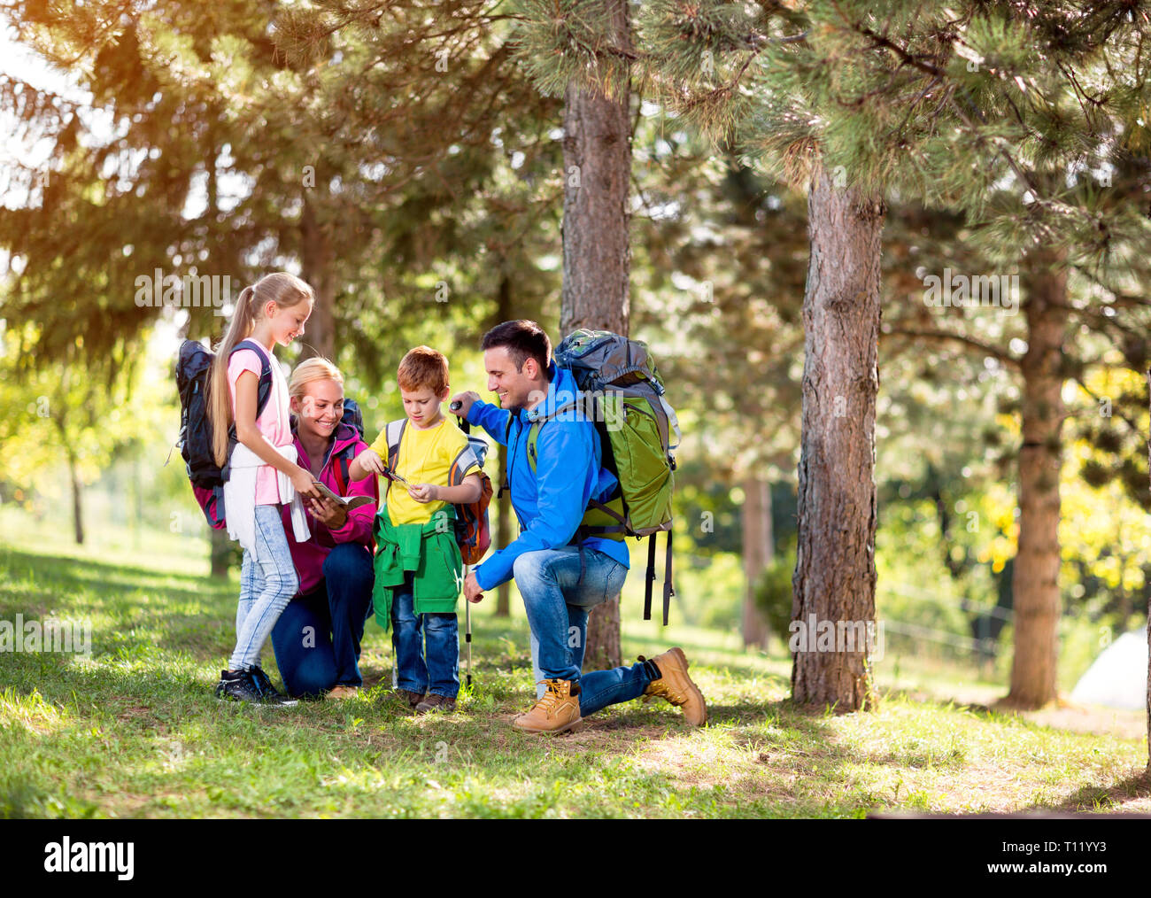 Family group hiking in woods together Stock Photo