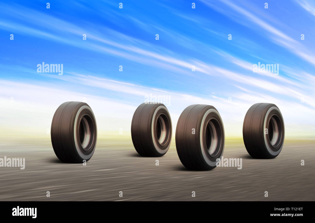 four black automobile wheels rush on the road with high speed Stock Photo
