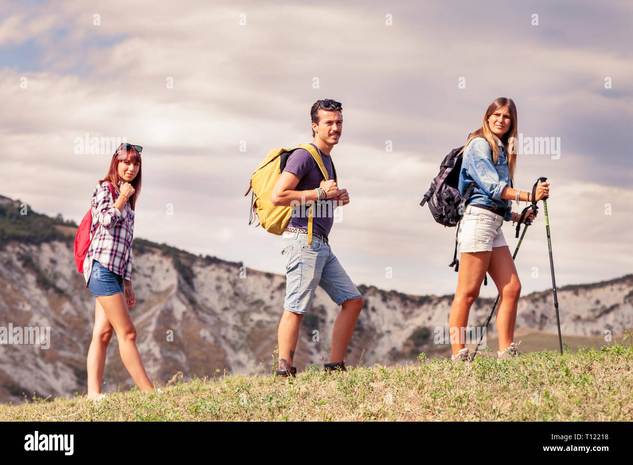 group of young hikers in the mountain in single file Stock Photo - Alamy