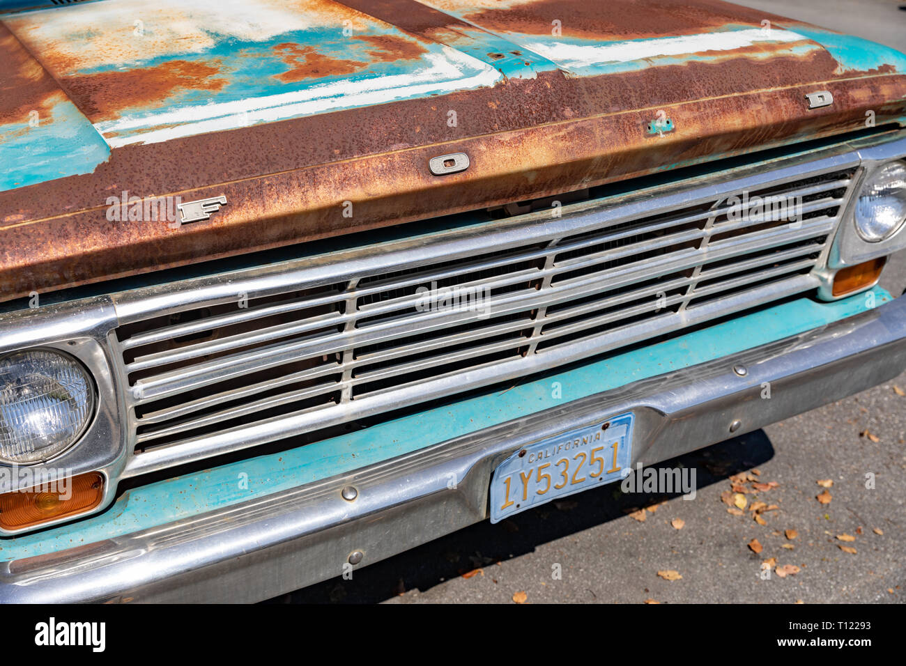 Front of old rusty turquoise Ford pickup truck with California license plate Stock Photo