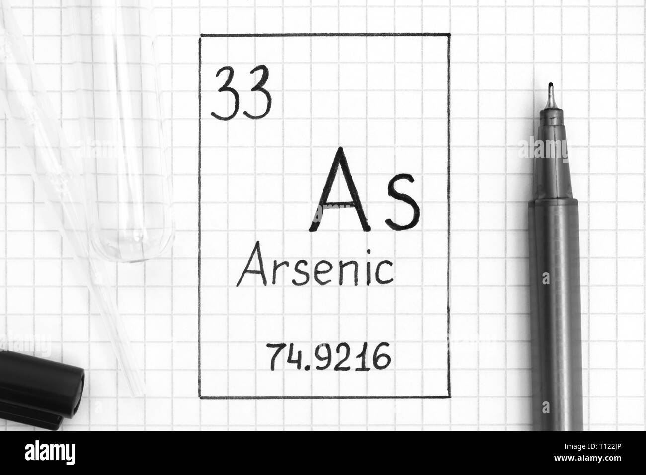 The Periodic table of elements. Handwriting chemical element Arsenic As with black pen, test tube and pipette. Close-up. Stock Photo
