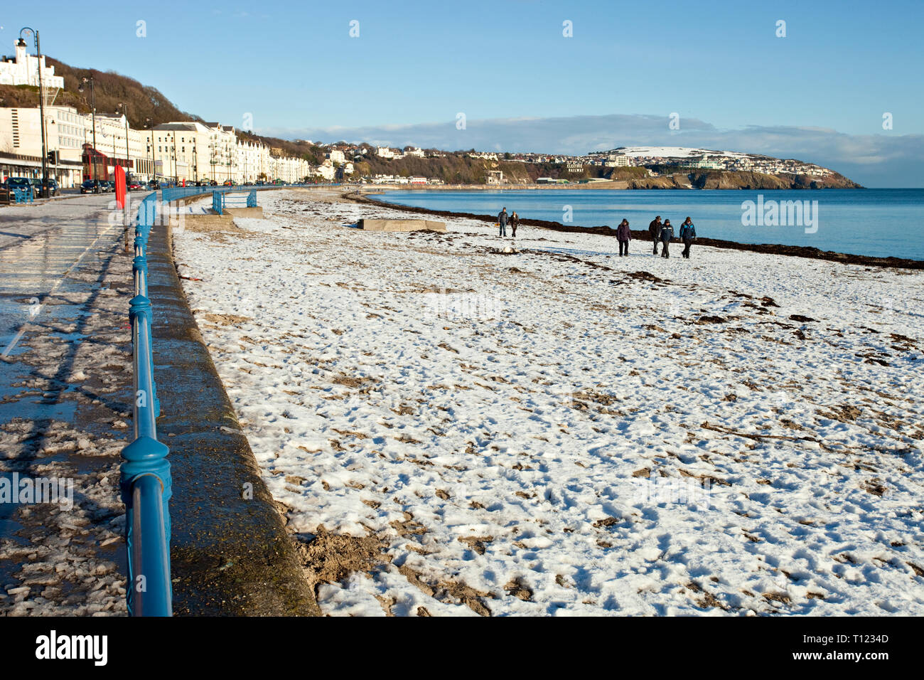 Europe, Britain, Isle of Man.  People take a stroll on Douglas beach on Christmas Day 2010. Stock Photo