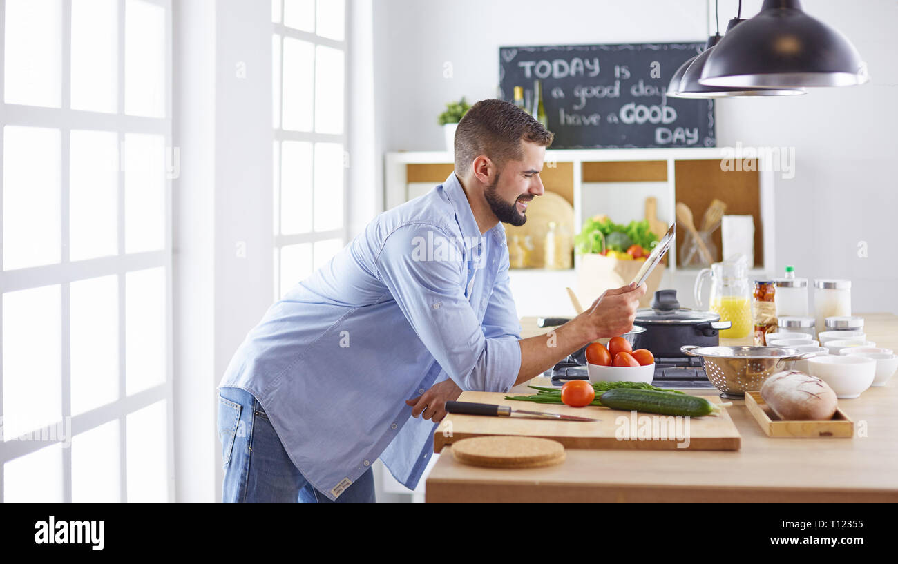 Smiling and confident chef standing in large kitchen Stock Photo