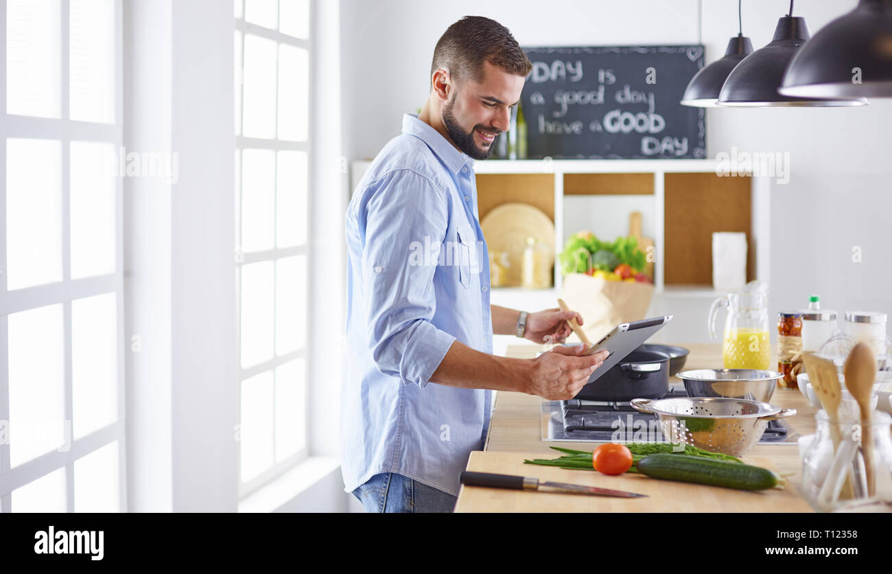 Smiling and confident chef standing in large kitchen Stock Photo