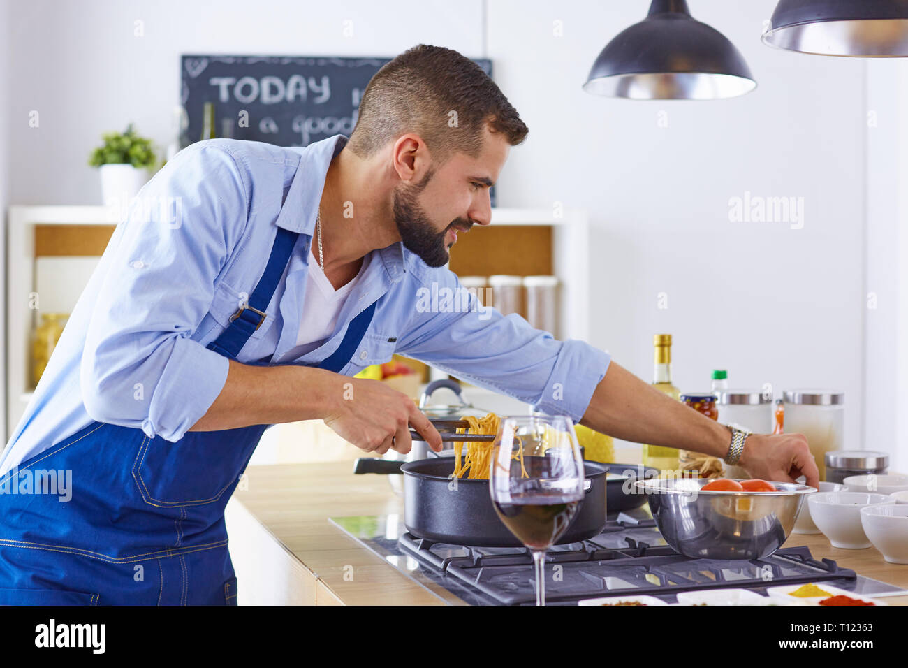 Smiling and confident chef standing in large kitchen Stock Photo