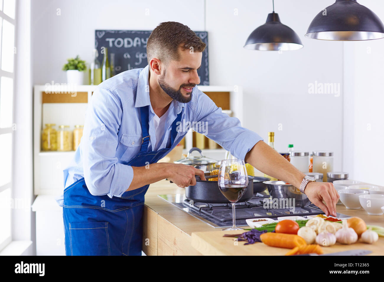 Smiling and confident chef standing in large kitchen Stock Photo