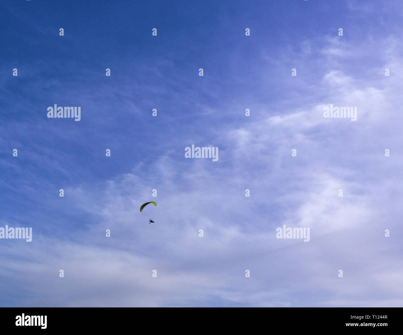 Paraglider flying, deep blue sky with some clouds. Clean Monday holiday. Athens, Greece 2019. Stock Photo
