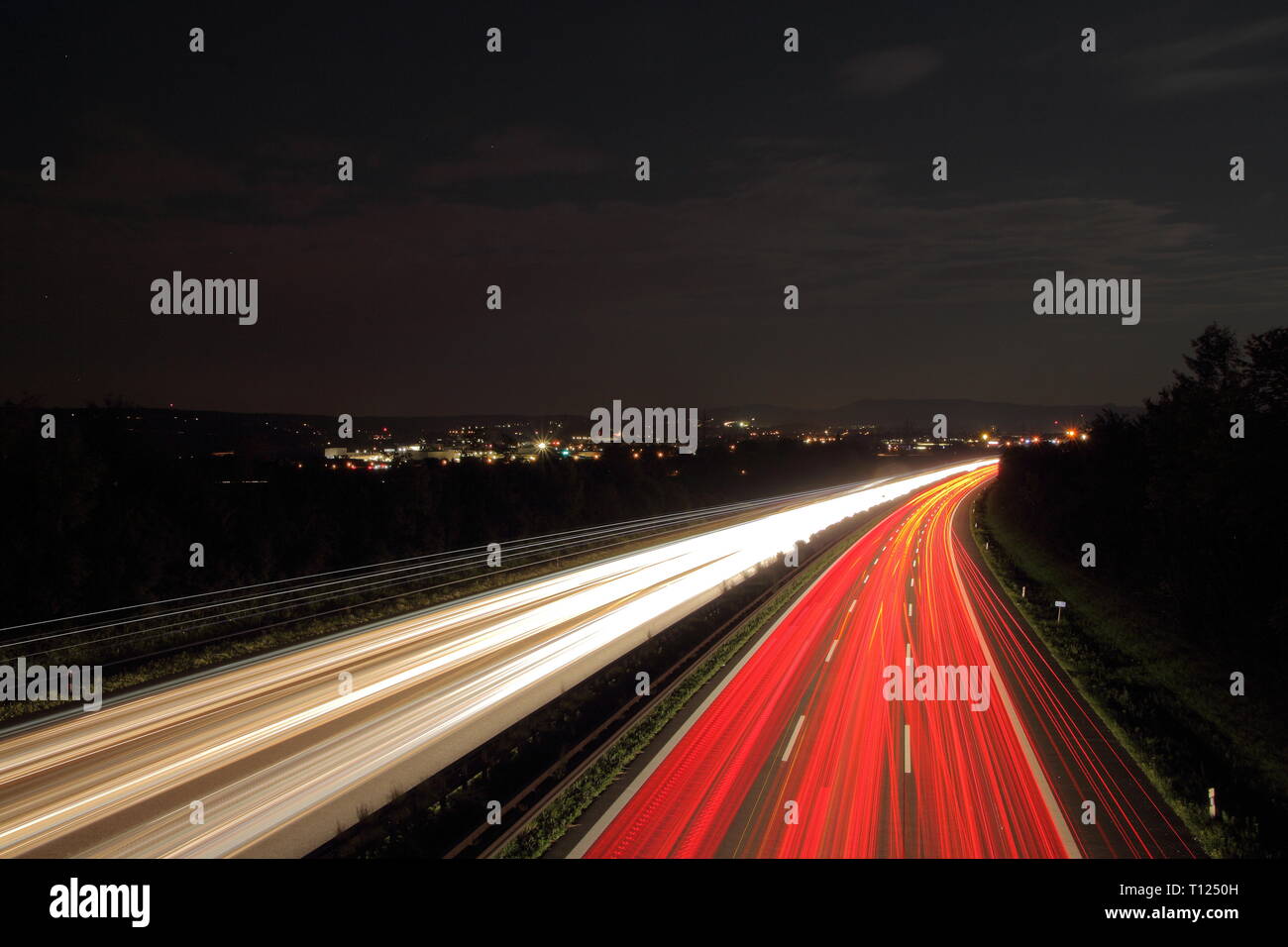 German Highway at night. Light trails on orad. Stock Photo