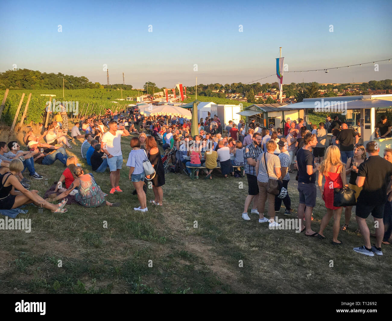 Mainz, Germany – June 29, 2018: People enjoying food, wine and drinks at a local fair called „Weinfest im Kirchenstück“, a wine festival in Hechtsheim Stock Photo