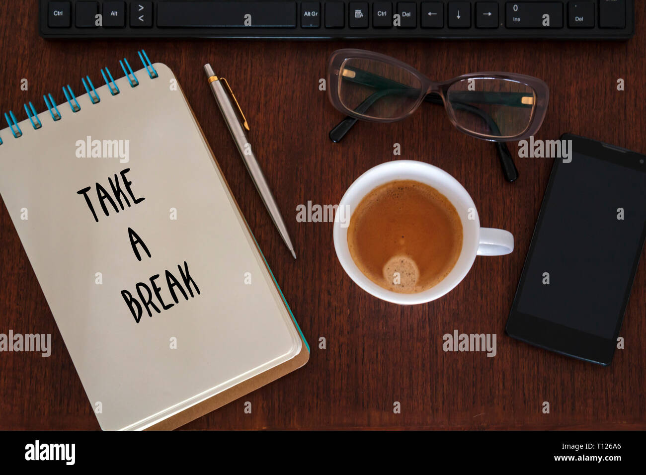 Desk with office accessories and Take a Break message. Stress