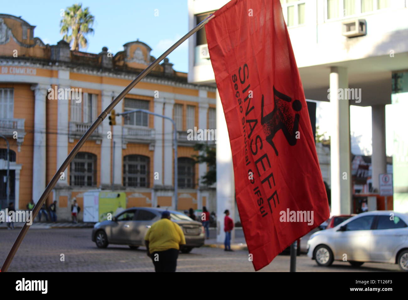 Red Union flag swings above street protests in Brazil against social security reform Stock Photo
