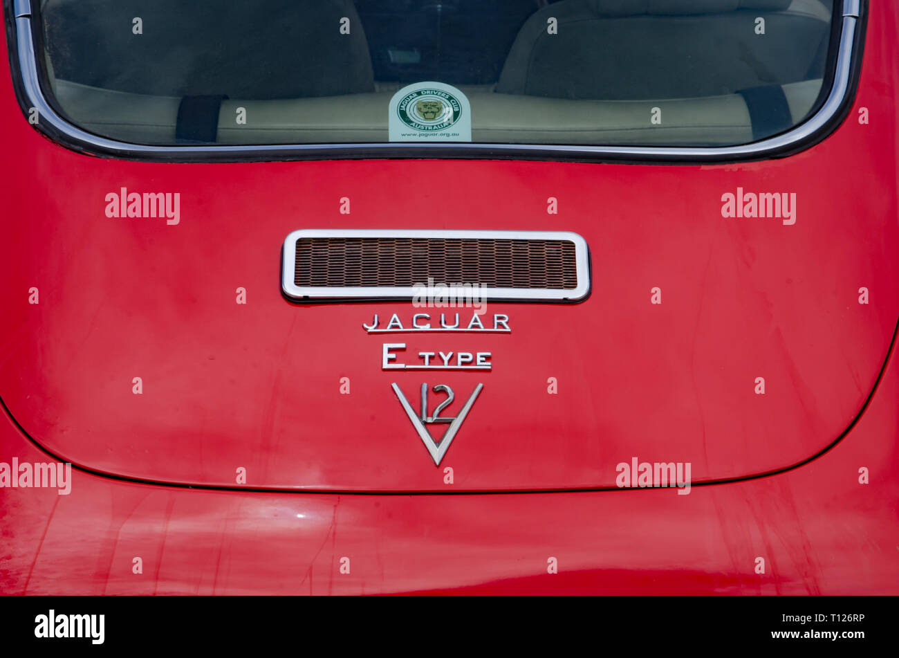 Back of a red E Type Jaguar V12 Coupe. Stock Photo