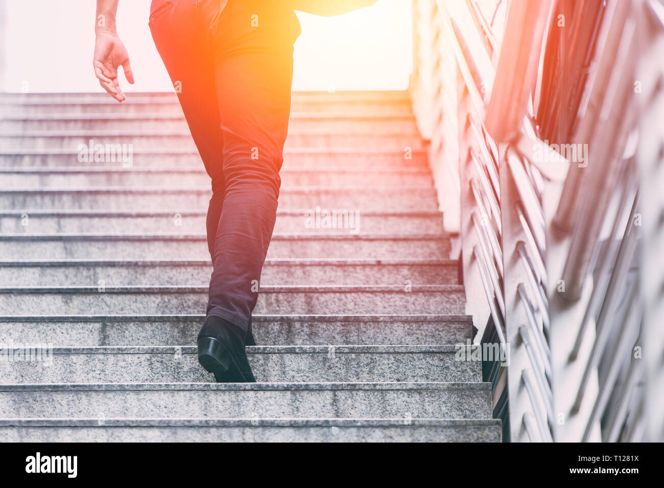 businessman step up climbing the career stairs to goal and winner concept. Stock Photo