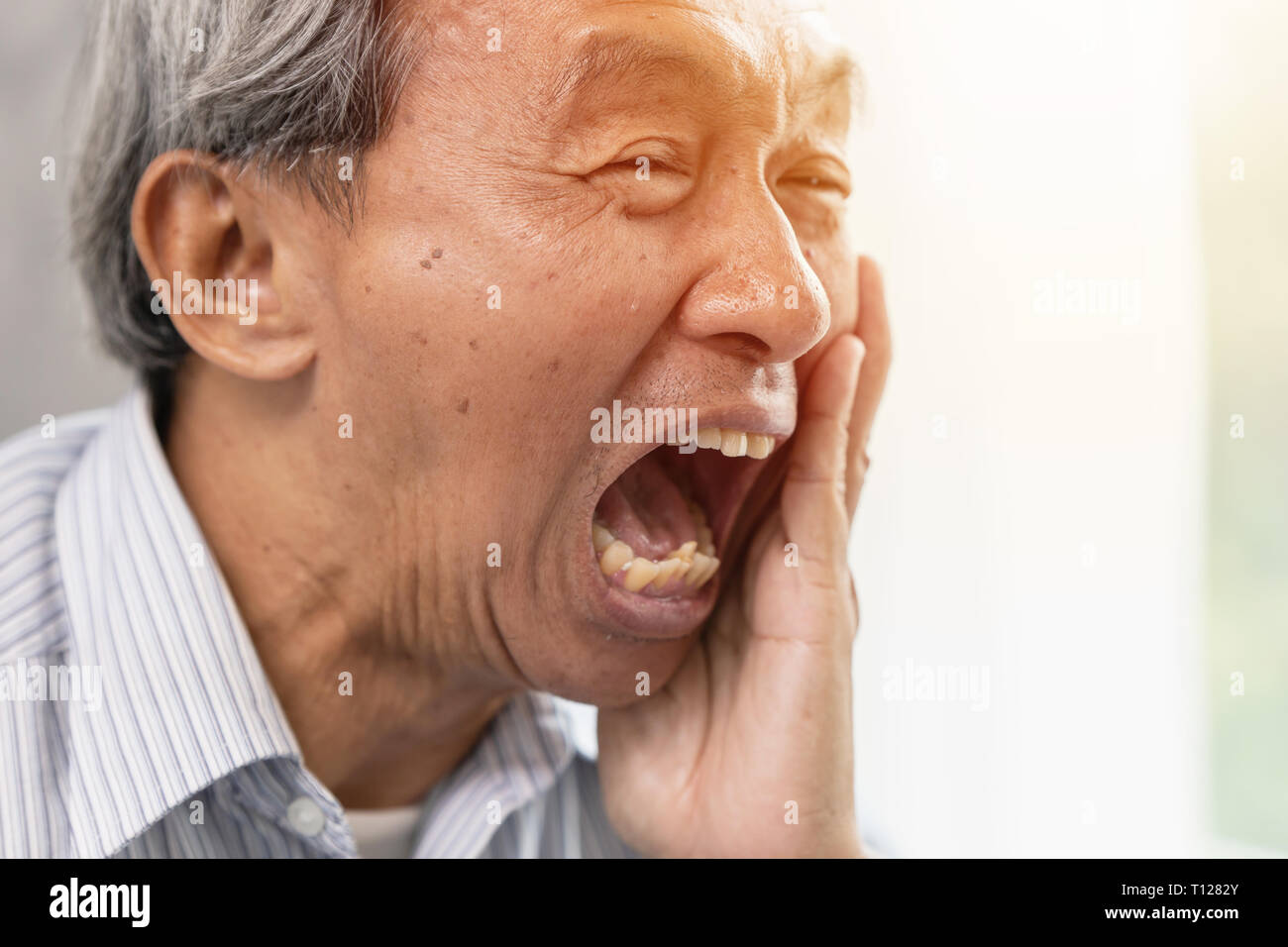 Asian elder serious pain tooth dental problem teeth caries decayed