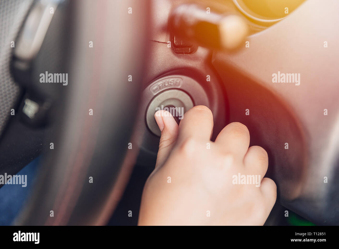 closeup hand twist turn car key to start ignite engine for drive Stock