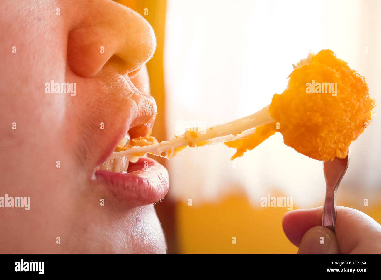 closeup eating cheese ball deep fried fatty tasty delicious food snack. Stock Photo