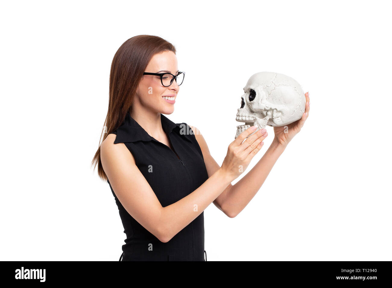 Young caucasian woman smiling on skull, isolated on white background Stock Photo