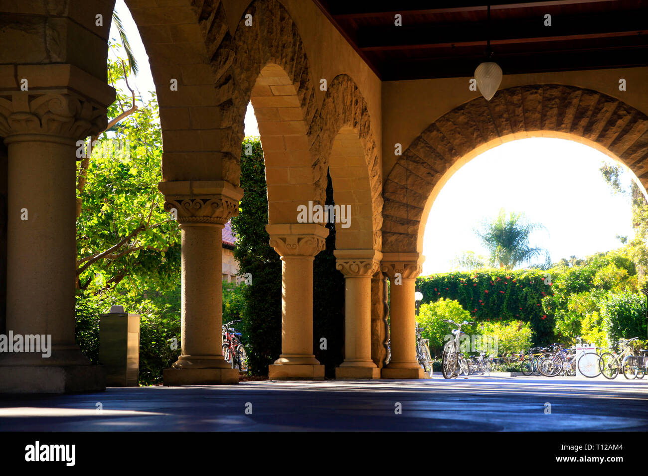 Long corridor at Stanford California. Amber sculpted stones columns Stock Photo