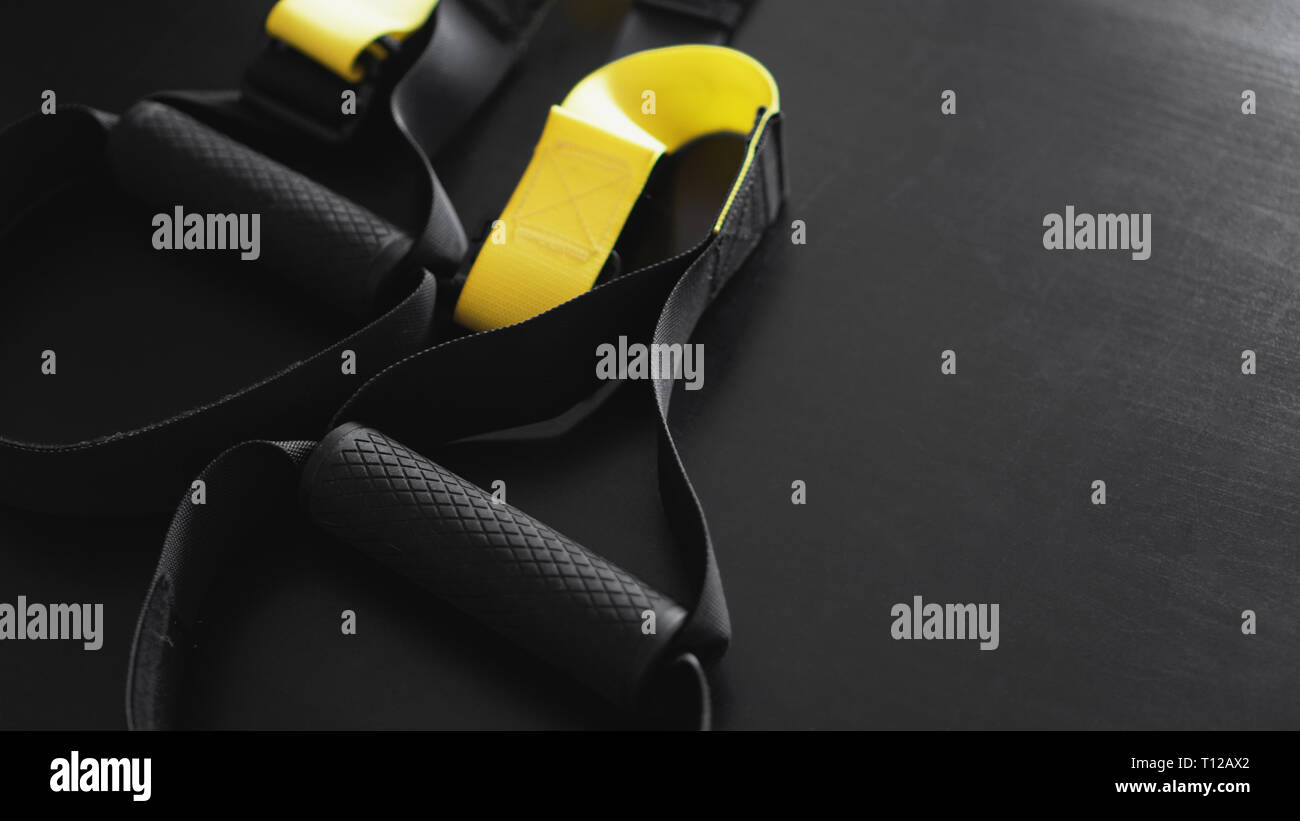 Black And Yellow Strap Functional Training Equipment On Grey