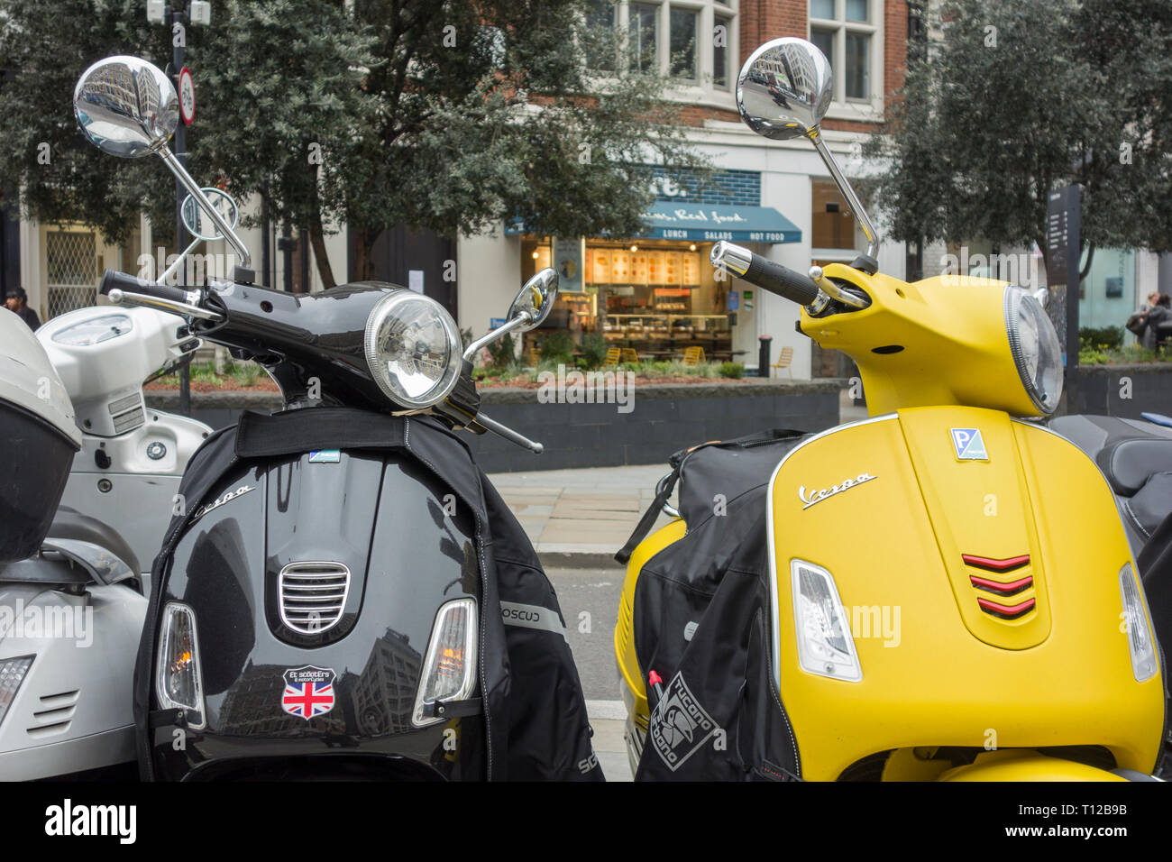Piaggio Vespa scooters in central London, UK Stock Photo