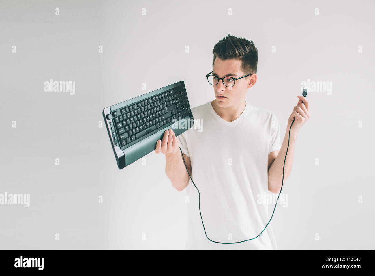 Funny computer geek isolated on white. Nerd is wearing glasses Stock Photo
