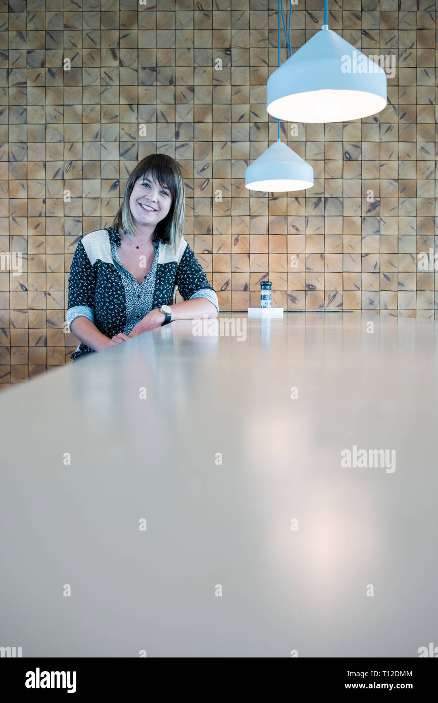 A young woman poses at a table in a cafe / restaurant Stock Photo - Alamy