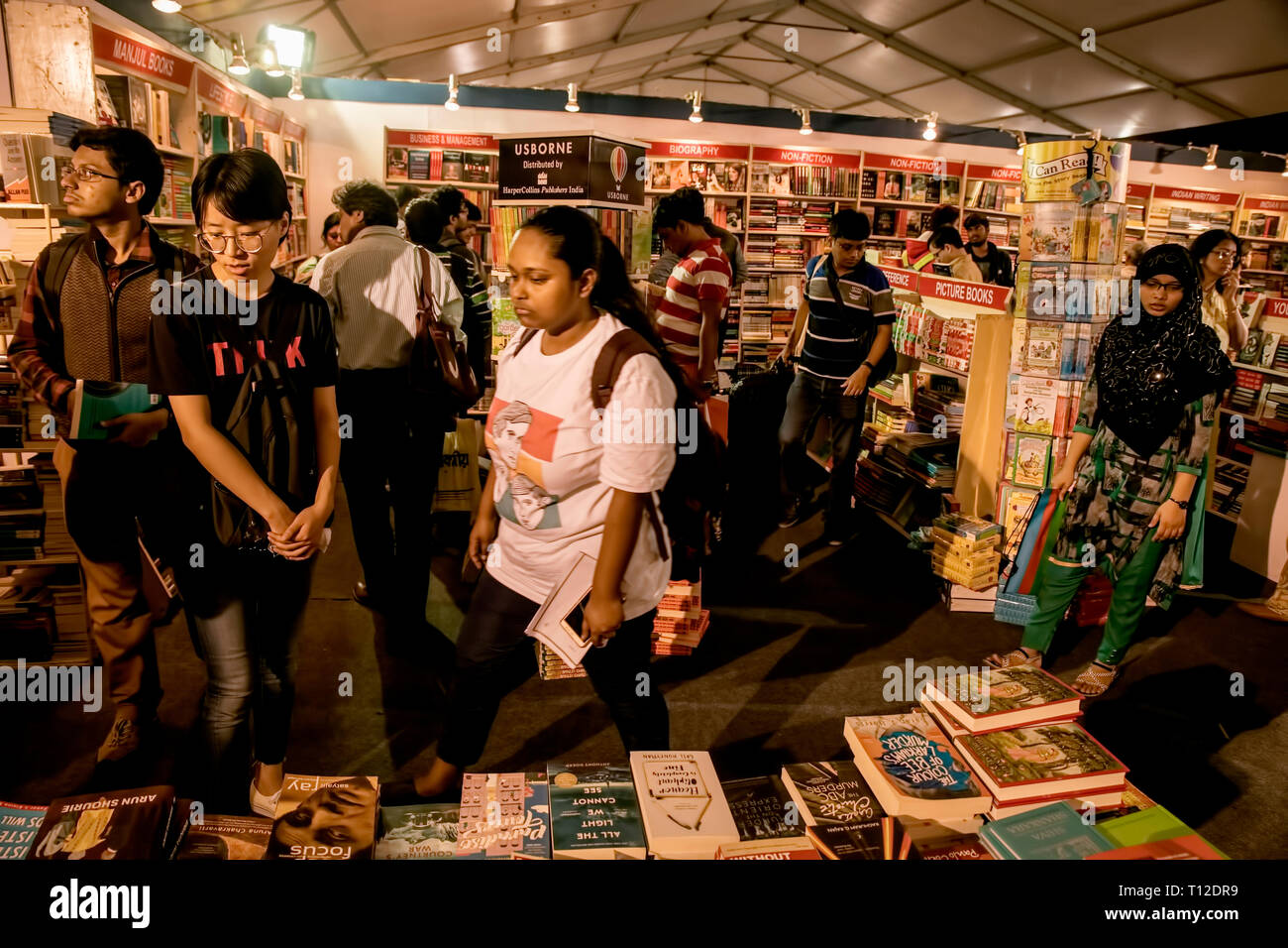The Calcutta Book Fair-2019,book,readers,carefully,looking at displayed ,books, at ,various stalls,by venders,inside,Book Fair,Pavilion,Kolkata,India. Stock Photo