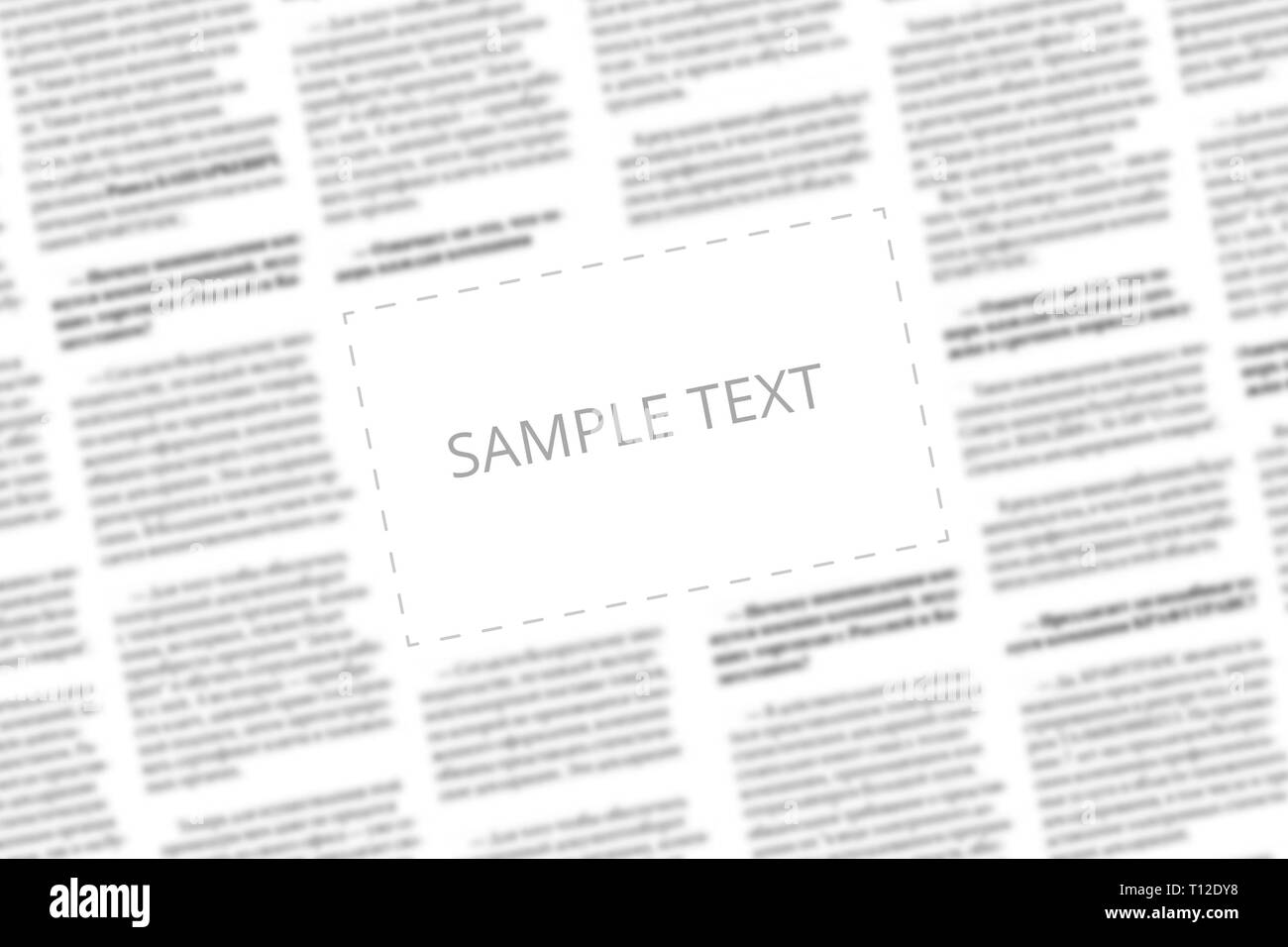 Angularly shot black and white newspaper with copy space in the middle. Written words Sample Text in the blank square on the blurred tabloid page back Stock Photo