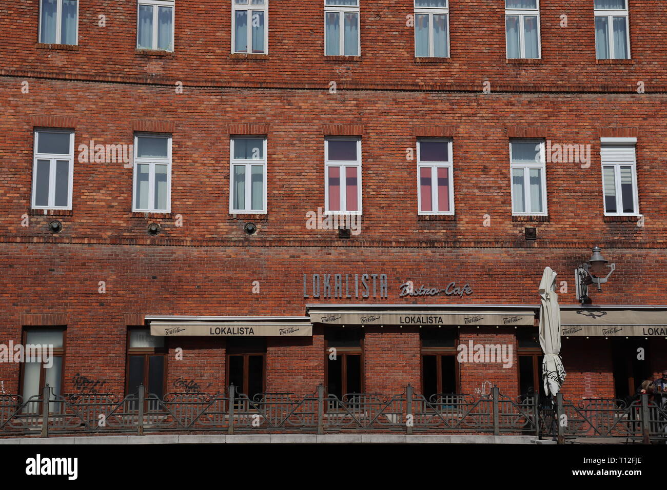 An old factory building revived as lofts. Brick walls with white windows. Stock Photo