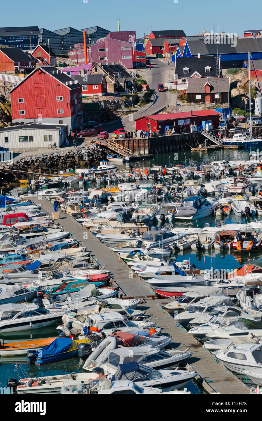 Brightly painted houses with fishing boats in the harbor, Ilulissat, Greenland Stock Photo
