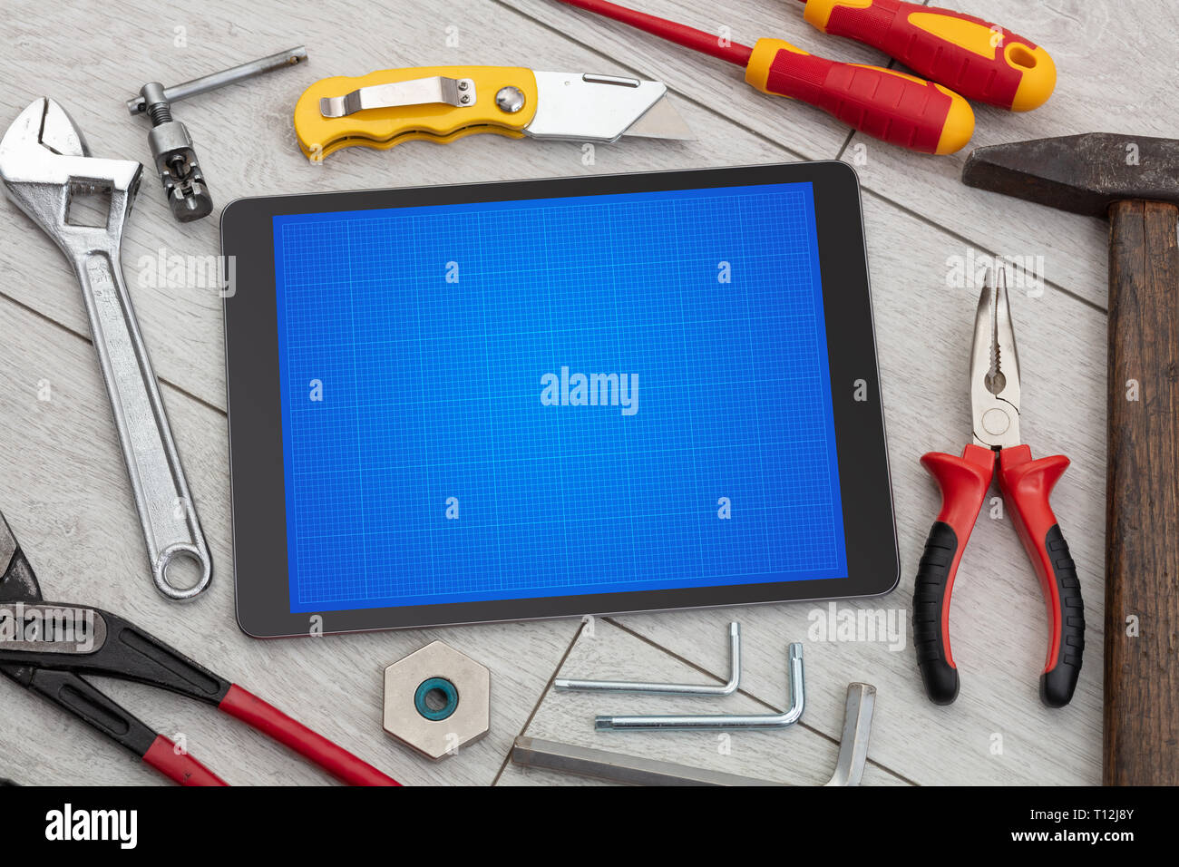 Household tools and tablet with grid screen concept Stock Photo